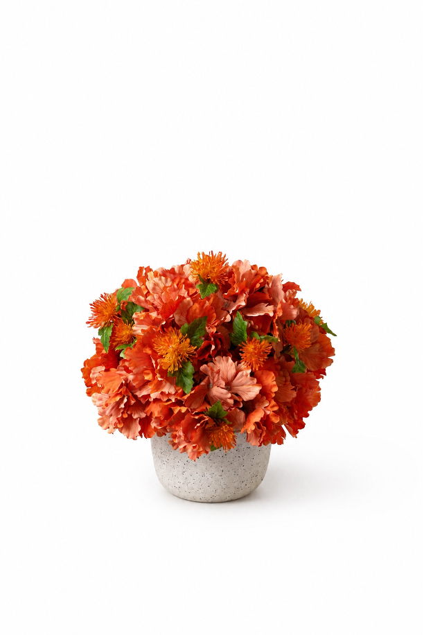 Full orange artificial flower arrangement in a white vase